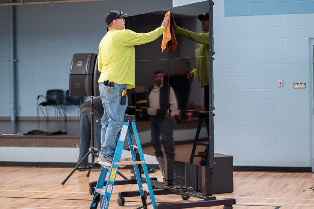Putting the finishing touches on the video wall Crescent Digital built for a JM Smucker event